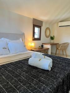a bedroom with a large bed with a pillow on it at Palma Seaside Villa 3 in Sarti