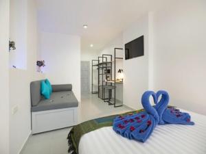 a bedroom with a bed with two swans on it at Colorize Boutique Hotel in Lamai +50 photos