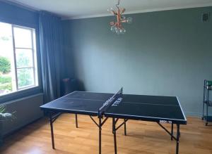 a ping pong table in a room with a ping pong racket at charmigt radhus i centrala Göteborg in Gothenburg