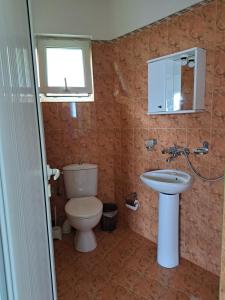 a bathroom with a toilet and a sink at Villa Veneta in Sinemorets +24 photos