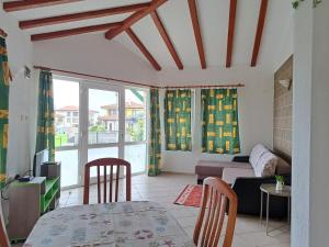 a living room with a table and a couch at Villa Veneta in Sinemorets
