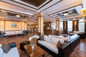 a lobby of a hotel with couches and tables at Evelina Palace Hotel in Bansko