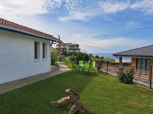 a yard with chairs and a table and a house at Villa Veneta in Sinemorets