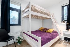 a bedroom with a bunk bed and a desk at Húsafell holiday homes in Húsafell