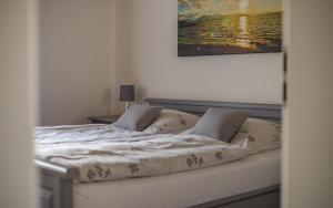 a bed in a bedroom with a picture on the wall at Ferienwohnung Schnappenblick in Grassau