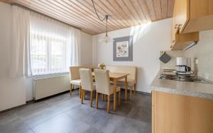 a kitchen and dining room with a table and chairs at Ferienwohnung Schnappenblick in Grassau
