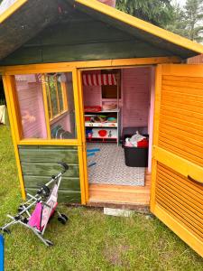 a small house with a bike parked outside of it at I - caly apartament z dużym tarasem Warmia Kids&chill raj dla dzieci in Gietrzwałd