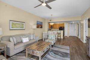 a living room with a couch and a table at Palms of Destin 2710 in Destin