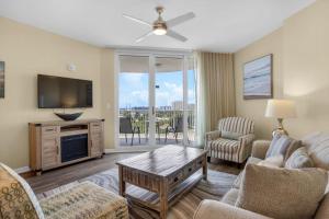 a living room with a couch and a tv at Palms of Destin 2710 in Destin