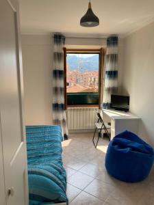 a room with a couch and a desk and a window at Appartamento Cavour in Ventimiglia