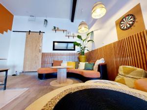 a living room with a couch and a table at COAST - Utopy Hostel in Biarritz