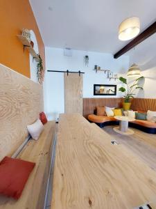 a room with a bed and a living room at COAST - Utopy Hostel in Biarritz