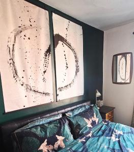a bedroom with two pictures on the wall above a bed at No.2 Boutique Art Townhouse  in Lincolnshire