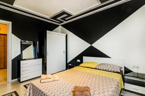 a bedroom with a bed and a black and white wall at Buddy in Varna City