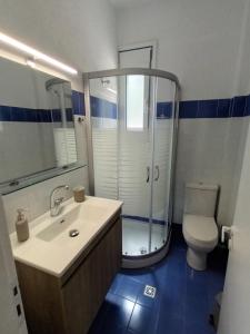 a bathroom with a shower and a sink and a toilet at Light Blue in Makry Gialos