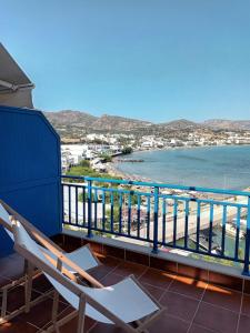 a balcony with a chair and a view of the ocean at Light Blue in Makry Gialos