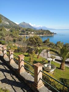 a park with a fence and a view of the water at Villa Eminenza in Cersuta di Maratea