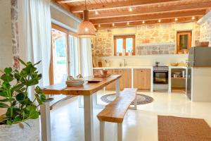 a kitchen with a wooden table and a refrigerator at Dolce Terra in Stari Grad