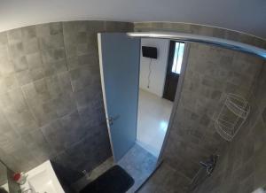a shower with a glass door in a bathroom at Summer House with Garden and Fruit Trees in Nea Makri