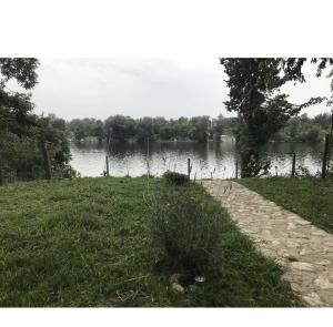 a path next to a body of water at green house at silver lake in Ostrovo