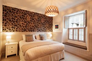 a bedroom with a large bed and a window at 27 The Terrace in St Ives