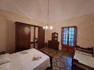 a bedroom with two beds and a room with a window at Cinque terrazze - Casa d'epoca con vista mare in Gallipoli +32 photos