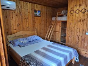 a bedroom with a bed and a ladder in a cabin at Casa Cris Will in Mamaia Nord