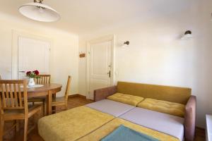 a living room with a couch and a table at Allee Apartments in Kuressaare