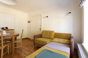 a living room with a couch and a table at Allee Apartments in Kuressaare