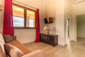 a living room with a couch and a window at La Poggiata in Monterotondo