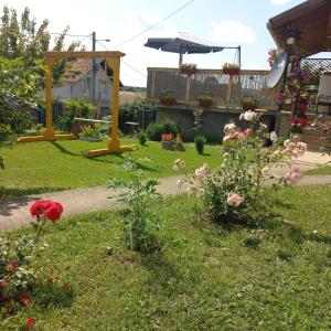 a garden with flowers and an umbrella in a yard at ꕤ Comfy Home ꕤ - Make yourself at home in Belgrade