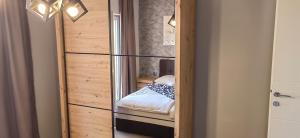 a room with a glass door leading to a small bedroom at Apartman Hana 2 in Rab
