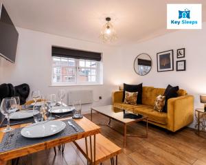 a living room with a table and a couch at Central Two Bedroom Apartment By Keysleeps Short Lets Hull With Free Parking Leisure Contractor in Hull