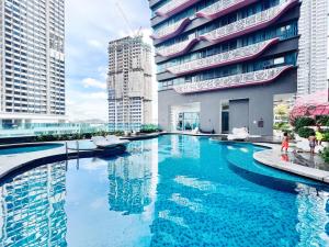 a large swimming pool in a city with tall buildings at Arte Plus Ampang By The Relax Stay in Kuala Lumpur