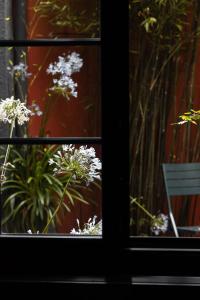 okno z widokiem na białe kwiaty i ławkę w obiekcie 2bis chambres d'hôtes w mieście Montreuil-sur-Mer