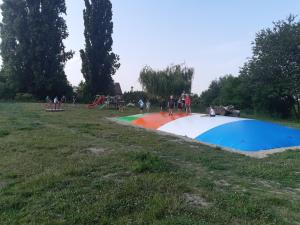 a group of people in a park with a playground at Apartmán u zámku in Smečno