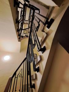 a spiral staircase in a building with black railings at Casa SAN MIGUEL en Tarazona in Tarazona de Aragón