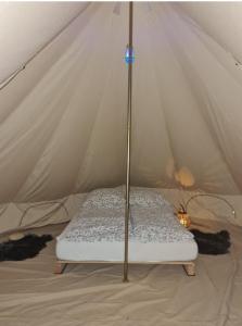 a mattress in a canvas tent with a mattress at Honeymoon Zelt im Ruhrpott in Oberhausen