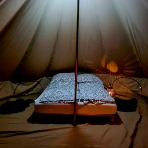 a bedroom with a bed in a tent at Honeymoon Zelt im Ruhrpott in Oberhausen