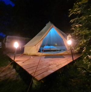 a tent on a wooden deck at night at Honeymoon Zelt im Ruhrpott in Oberhausen