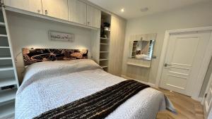 a bedroom with a large bed and a closet at Nature's Retreat: 1B Home Christchurch, Dorset in Christchurch