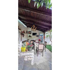 a patio with a table and chairs under a wooden ceiling at Guesthouse Alvaro Kadiu in Berat
