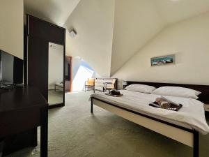 A bed or beds in a room at Penzion Félix