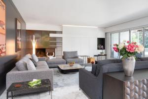 a living room with two couches and a fireplace at Park Villa Geneva - Swiss Hotel Apartments in Geneva