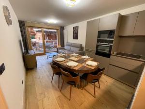 a kitchen and dining room with a table and chairs at GESPERE LE STELLA in Les Gets
