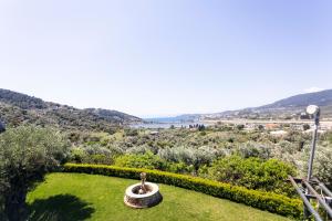 a view of a park with a fountain in the grass at Dohos Skiathos Suites in Skiathos