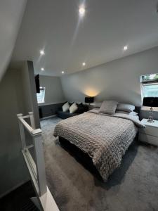 a bedroom with a large bed and a window at Dyserth Waterfalls apartment in Dyserth