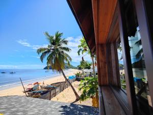 a view of the beach from a house at Villa Mbolatsara in Nosy Be