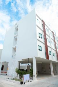 a white building with a sign on the side of it at S1 Trang Hotel in Trang