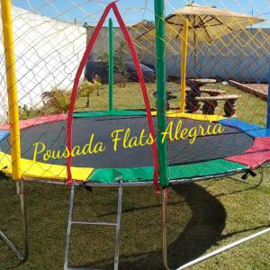 a merry go round with the words pussola fladesh albuquerque on it at Pousada Flats Alegria in Olímpia